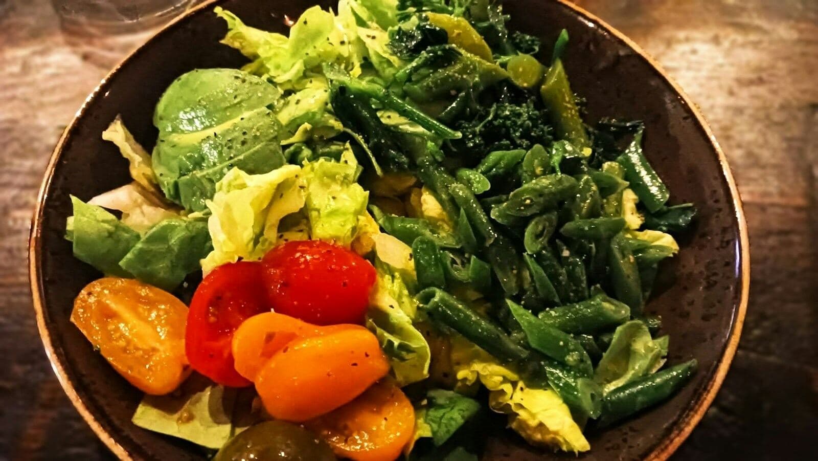 A bowl of greens and roasted tomatoes